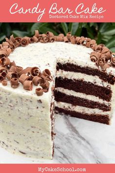 a cake with white frosting and chocolate sprinkles