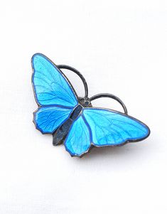 Sterling silver blue enameled Butterfly brooch by Aksel Holmsen Oslo Norway in mint condition.  After training with David-Andersen, Holmsen established his own workshop in 1904. His business produced high quality pieces of jewellery. This butterfly brooch is a good example with translucent blue enamel that shows the engraved surface beneath. Brooch measures 1.35 by .75 inches, weighs 4.9 grams. Oslo Norway, Butterfly Brooch, Silver Enamel, Blue Butterfly, Silver Blue, Sterling Silber, Mint Condition, Norway, Brooch Pin