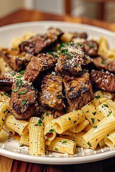 Ingredients:  - 1 lb beef sirloin tips - 2 tbsp butter - 4 cloves garlic, minced - Salt and pepper to taste - 8 oz rigatoni pasta - 1 cup shredded mozzarella cheese - Fresh parsley, chopped (for garnish)  Instructions: 1. Season steak tips with salt and pepper. 2. In a skillet, melt butter and add minced garlic.  3. Sear steak tips in the garlic butter until cooked to your liking. 4. Cook rigatoni according to package instructions; drain. 5. Toss rigatoni with mozzarella cheese until melted. 6. Serve steak tips over cheesy rigatoni. Garnish with parsley. Cheesy Rigatoni, Season Steak, Sear Steak, Good Steak Recipes, Cooking Soul Food, Gourmet Food Plating, Steak Dishes, Steak Tips, Sirloin Tips