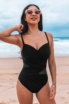 Embrace sophistication in our Onyx Mesh Ruched One-Piece Swimsuit. With its sleek black hue and alluring mesh panels, this swimsuit offers both style and allure for your poolside lounging. Product code: CAA12E4F064AA Features:  V-neckline Adjustable cami straps Removable soft cups Mesh inserts Ruching Classic bum coverage Wash Method: Regular Wash Lining: 92%POLYESTER,8%SPANDEX Material: 80%NYLON,20%SPANDEX. Black Nylon Tankini For Pool, Black Nylon Tankini For The Pool, Black Lined Tankini For Pool, Black Underwire Nylon Tankini, Black Ruched Nylon Swimwear, Sleeveless Mesh Swimwear With Lined Body, Black Swimwear With Mesh Back For Pool, Party Swimwear With Mesh Back In Black, Black Mesh Fitted Swimwear