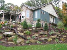 a large house sitting on top of a lush green hillside next to a tree filled forest