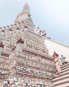 girl walking down steps at wat arun in bangkok, thailand White Temple