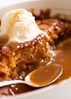 a close up of a bowl of food with ice cream on top and caramel sauce