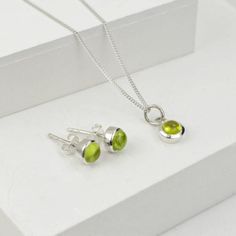 Beautiful Jewellery Set with Peridot gemstone made in sterling silver.  Crystal gemstone, an olive color to bright green, is believed to protect from dark energy. It is also called as an evening emerald because of the way it glows in the night. Peridot is the birthstone of August and an ideal gift for 16th marriage anniversary.  The set consists of birthstone earring studs and pendant necklace.   The necklace comes in 16" and 18" fine curb chain Please avoid in contact with chemicals and use silver cloth to clean. Dark Energy, Marriage Anniversary, August Birthstone Jewelry, Forever Jewelry, August Birthstone, Peridot Gemstone, Jewelry Ring Box, Men's Jewelry Rings, Jewellery Set