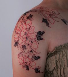 a woman's shoulder with flowers on it