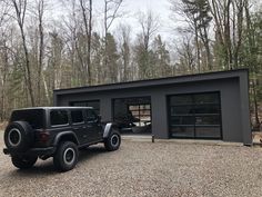 a black jeep parked in front of a garage