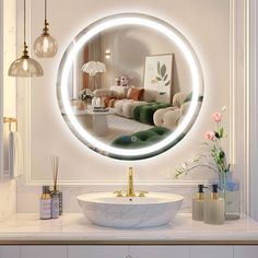 a bathroom with a round mirror on the wall next to a sink and vases