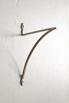 a blue wall mounted hook on the side of a white wall