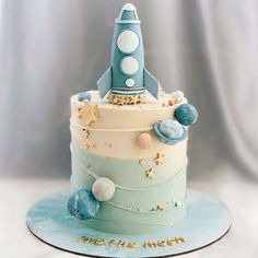 a blue and white cake with a rocket on top