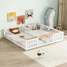 a child's bedroom with two white beds and toys on the floor in front of them