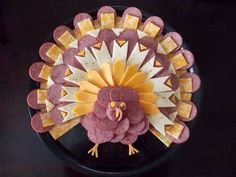 a turkey made out of crackers on a plate