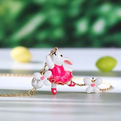 How cute is this pink bunny rabbit necklace accented with cultured pearls and white enamel flowers? Spring is in the air every day with this beautiful necklace, perfect for Easter gifting and hand enamelled, set on an gold plated sterling silver necklace. The ideal accessory to kick off your Spring, Summer look.Carat Weight: 1.5 ctStone Size: 6 mmNumber of Stones: 1 Stone Color: Diamond WhiteStone Shape: RoundWeight: 4.9 gWidth: 16 mmHeight: 23 mmThickness: 7.7 mmPlating Color: Yellow GoldLength Whimsical White Jewelry For Valentine's Day, Pink Jewelry For Easter Gift, Whimsical White Pendant Jewelry, Charming Pink Pendant Necklace, Whimsical White Pendant Necklace, Rabbit Necklace, Dreamy Garden, Spring Is In The Air, Pink Bunny