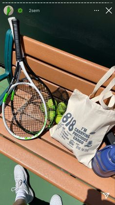 a tennis racket and bag sitting on a bench next to a pair of shoes