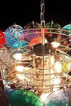 a chandelier with many different colored glass plates on it