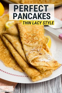 pancakes on a plate with lemon wedges and powdered sugar in the middle, text overlay reads perfect pancakes thin lacy style