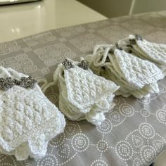 three crocheted baby diapers sitting on top of a table