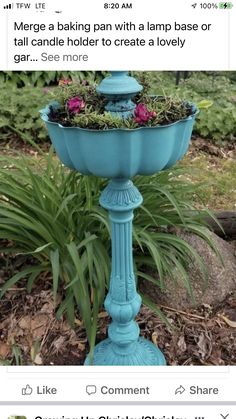 a blue bird bath with flowers in it