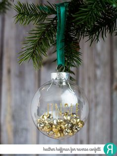 an ornament hanging from a christmas tree with gold coins in it's bottom