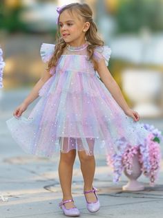 Your precious girl will look and feel like an enchanting princess in this magical tiered ruffle dress. Decorated with moon and star sequins, this rainbow number will have her shining and beaming with joy with every step!  Lightweight fabric feels good on her skin, keeping her cool and comfy even on warm summer days. Re Unicorn Dresses For Kids, Bday Dress, Kid Birthday Outfits, Toddler Birthday Dress, Star Sequins, Mermaid Theme Birthday Party, Princess Dress Kids, Pastel Girl, Fairy Birthday Party