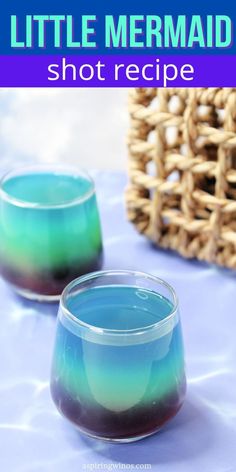 two glasses filled with blue and green liquid sitting on top of a table next to a wicker basket