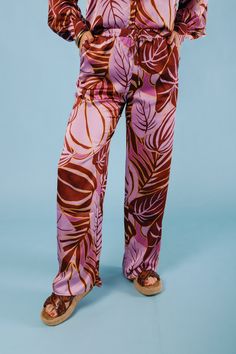 Add some playful flair to your wardrobe with The Tropical Satin Pants. Featuring a vibrant tropical print, these satin pants boast a stylish wide leg cut, perfect for any warm weather occasion. Stand out and make a statement in these quirky and fun pants that are sure to turn heads. Fabric Content: 100% POLYESTER Chic Wide Leg Bottoms With Bold Print, Trendy Full-length Pants For Vacation, Trendy Pants For Vacation, Trendy Full Length Pants For Vacation, Chic Bold Print Summer Pants, Chic Wide Leg Bottoms With Vibrant Print, Summer Tropical Printed Pants, Tropical Printed Summer Pants, Tropical Printed Vacation Pants