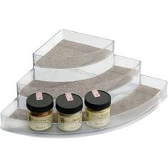 three jars are sitting on a clear tray