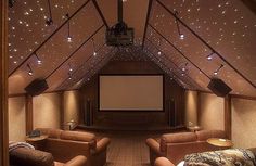 an empty room with two couches and a projector screen in the ceiling,