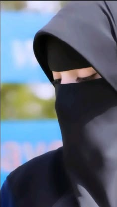 a person wearing a black mask and hood