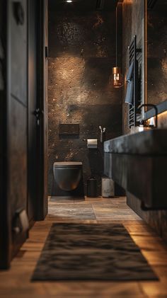 a bathroom with black walls and wooden floors