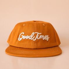 A burnt orange flat brim hat that reads, Good Times in ivory embroidered text. Stationary Notebook, Cool Hat, Embroidered Text, Hat Aesthetic, Puzzle Jewelry, Orange Hats, Flat Brim Hat, Distressed Hat, Let The Good Times Roll