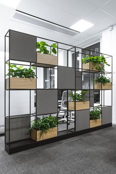 an office cubicle with plants growing in it