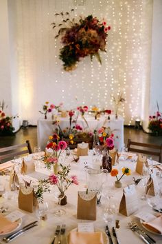 the table is set with flowers and place settings