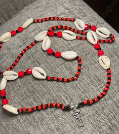 This unique piece is a tribute to the Orisha, Eleguá! With the traditional red and black seed beads, Cowrie shells, large Red Coral beads (faceted), Jet Stone beads (small faceted & tooth-shaped) with Sterling Silver beads and his signature key; this is a very favorable style of Collar/Eleke! Attributes of Eleguá Eleguá (Elegguá) is sometimes represented as a child, and sometimes as an old man.  He represents the beginning and end of life, and the opening and closing of paths in life.  Sometimes known as the trickster, he likes to play jokes on people.  He enjoys candy and toys.  Despite his childlike nature, however, he's a very powerful Orisha.  He's one of the Warriors (along with Ogún, Ochosi and Oshun).  Eleguá is always mentioned first in any ceremony, because without his permission, Spiritual Black Beaded Jewelry For Beach, Spiritual Black Beads Jewelry For Beach, Black Beaded Necklaces For The Beach, Red Beaded Bracelet With 108 Beads For Festival, Red Beaded Bracelets With Black Beads For Festival, Red And Black Beaded Necklace For Festivals, Traditional Red Beaded Bracelets For The Beach, Handmade Red Beaded Bracelets For Beach, Adjustable Red Beaded Necklace For Beach