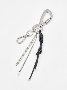 the key chain is attached to a metal hook with two chains hanging from it's side