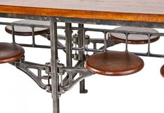 four stools and a table made out of metal with wooden top on white background