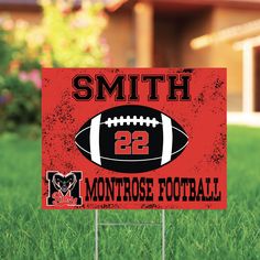 a football themed yard sign in the grass