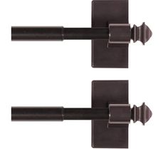 pair of black metal curtain rods on white background