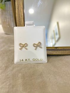 These adorable bow tie earrings are perfect for anyone who loves a good cute earring to add a little sparkle. These earrings are crafted all around with 1.1mm of clear Cubic Zirconia stones. This is a stud earrings with a screw back. Screw backs are great as its less likely to fall out. Post length is 8.5mm. The pair weight about 0.76gr. All photos are natural and have been taken to the best of our ability. ❤ We guarantee that the item is identical as the actual photo seen. ❤ We Guarantee 100% P Gold Earrings With Bow Tie Detail For Gift, Gold Bow Tie Earrings For Gift, White Bow Tie Jewelry As Gift, White Bow Tie Jewelry For Gift, Cute Anniversary Jewelry With Bow, Diamond Bow Jewelry As Gift, Bow Cubic Zirconia Jewelry For Anniversary, Cubic Zirconia Bow Jewelry For Anniversary, Bow Detailed Cubic Zirconia Jewelry For Anniversary