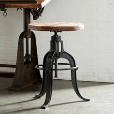 an industrial style bar stool with wooden seat