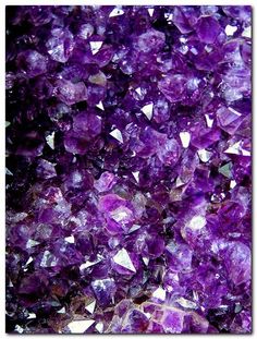 a pile of purple crystals sitting on top of a table