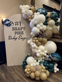 the balloon arch is decorated with footballs and balloons