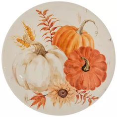 a plate with pumpkins and flowers painted on it