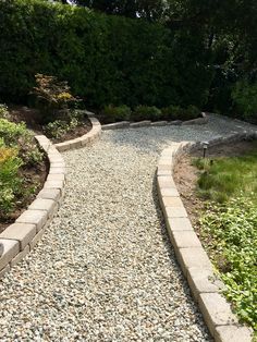 a stone path in the middle of a garden