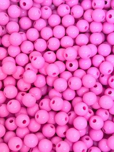 many pink beads are stacked together in a pile