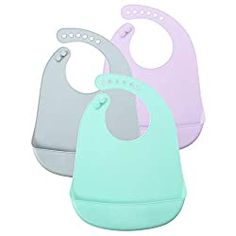 three bibs are shown in pastel colors and one is blue, the other has pink