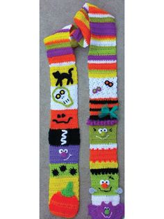 two colorful crocheted wristbands with faces on them