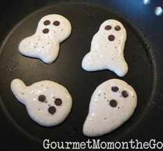 four ghost cookies cooking in a skillet