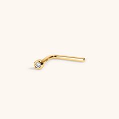 Our dainty Tiny Diamond nose stud in 14k gold gives you the perfect amount of shine for everyday - think of it as our nose stud version of our signature Tiny Crystal Studs. A diamond nose stud is the perfect piece to add a bit of an edge to your look in brilliant, beautiful solid 14k gold. Our diamond nose stud is safe for sensitive skin and healing piercings. Specs & Sizing Solid 14k gold nose stud White diamond in 2mm bezel 6.5mm post, 6mm after the bend, 20g wire (0.8MM) Classic 14k Yellow Gold Nose Studs, Elegant Tiny Yellow Gold Nose Studs, Elegant Everyday Yellow Gold Nose Studs, Elegant Yellow Gold Nose Studs, Elegant 14k Yellow Gold Nose Rings, Minimalist 14k Yellow Gold Nose Rings, Healing Piercings, L Shaped Nose Ring, Diamond Nose Stud