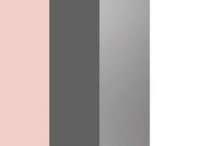 the side of a tall metal object with pink and grey stripes on it's sides