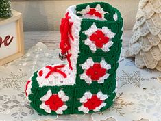 a crocheted christmas boot sitting on top of a table